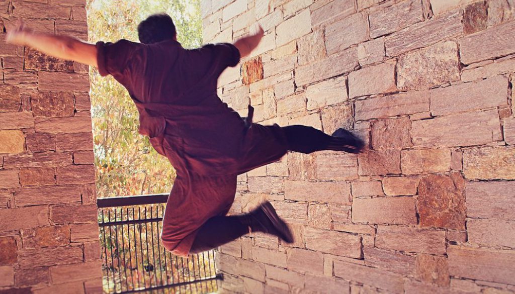Master Kongling while executing a spectacular flying Kung Fu kick against a rock wall (in his guan)